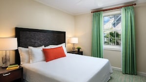 A hotel room with a large bed, two bedside tables, a window with curtains, and a view of the outside. - Cozy 1-BR Villa in fantastic Harborside at Atlantis in Paradise Island (Paradise Island)
