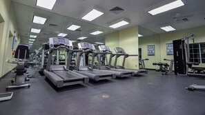 A gym with treadmills, exercise bikes, and weight machines.