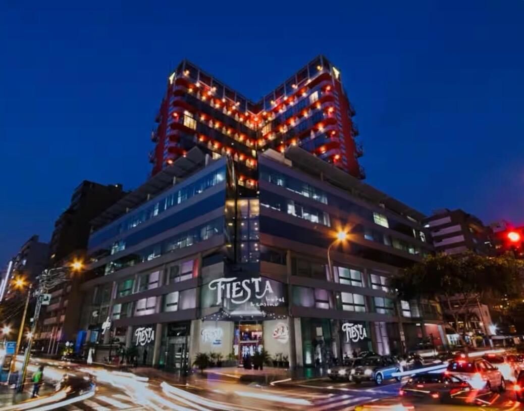 A multi-story building with a distinctive angular design, featuring a prominent 'Fiesta' sign on the ground floor.