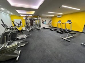 A gym with various exercise equipment, including treadmills, elliptical machines, and weight machines. - Modern Duplex with Terrace | Alcanfores (Miraflores)