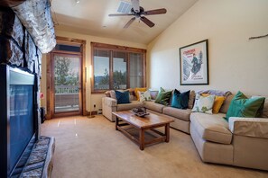 A living room with a sofa, a coffee table, and a ceiling fan. - TL2303 | Top Floor | Perfect Steamboat Getaway | A/C | 10 Hot Tubs (Steamboat Springs)