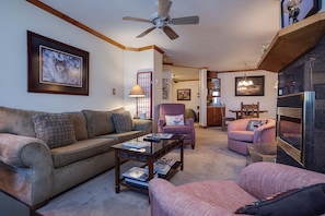 A living room with a sofa, armchairs, a coffee table, a fireplace, and a ceiling fan. - TR1201 | Beautiful Home | Close to Skiing | A/C | 10 Hot Tubs (Steamboat Springs)