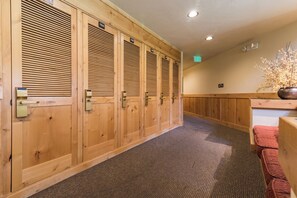 A row of wooden lockers with numbers on the doors, a carpeted floor, and a plant on the right. - TR1304 | Perfect Mountain Getaway | Modern Décor | A/C | Hot Tubs (Steamboat Springs)
