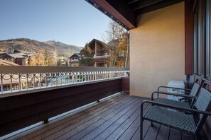 A balcony with a view of a mountain, wooden deck, metal railing, and two chairs. - TL2209 | Close to Slopes | A/C | 10 Hot Tubs | 4 Pools (Steamboat Springs)