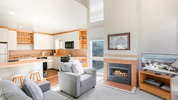 A modern kitchen with white cabinets, a microwave, and a stove.