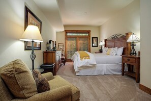 A bedroom with a bed, bedside tables, a chair, and a desk. - EL5308 | Beautifully Designed | Comfort | Convenience | Air Chilling | Hot Tub (Steamboat Springs)