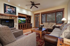 A living room with a fireplace, television, and seating area. - EL5107 | Private Patio with Hot Tub | Air Chilling | Close to Skiing | 4 Pools (Steamboat Springs)
