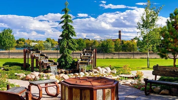 A park with wooden benches, a wooden gazebo, and a waterfall. - Great Falls Studio Suite | Free Breakfast! (Great Falls)