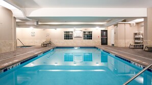 An indoor swimming pool with clear lane markings, a lifeguard station, and a no diving sign. - Missouri River View Suite | Free Breakfast! (Great Falls)