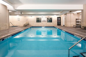An indoor swimming pool with clear lane markings, a lifeguard station, and a no diving sign. - Missouri River View Suite | Free Breakfast! (Great Falls)