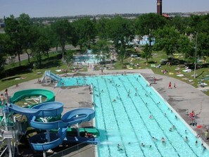 A water park with multiple swimming lanes, water slides, and a large pool area.