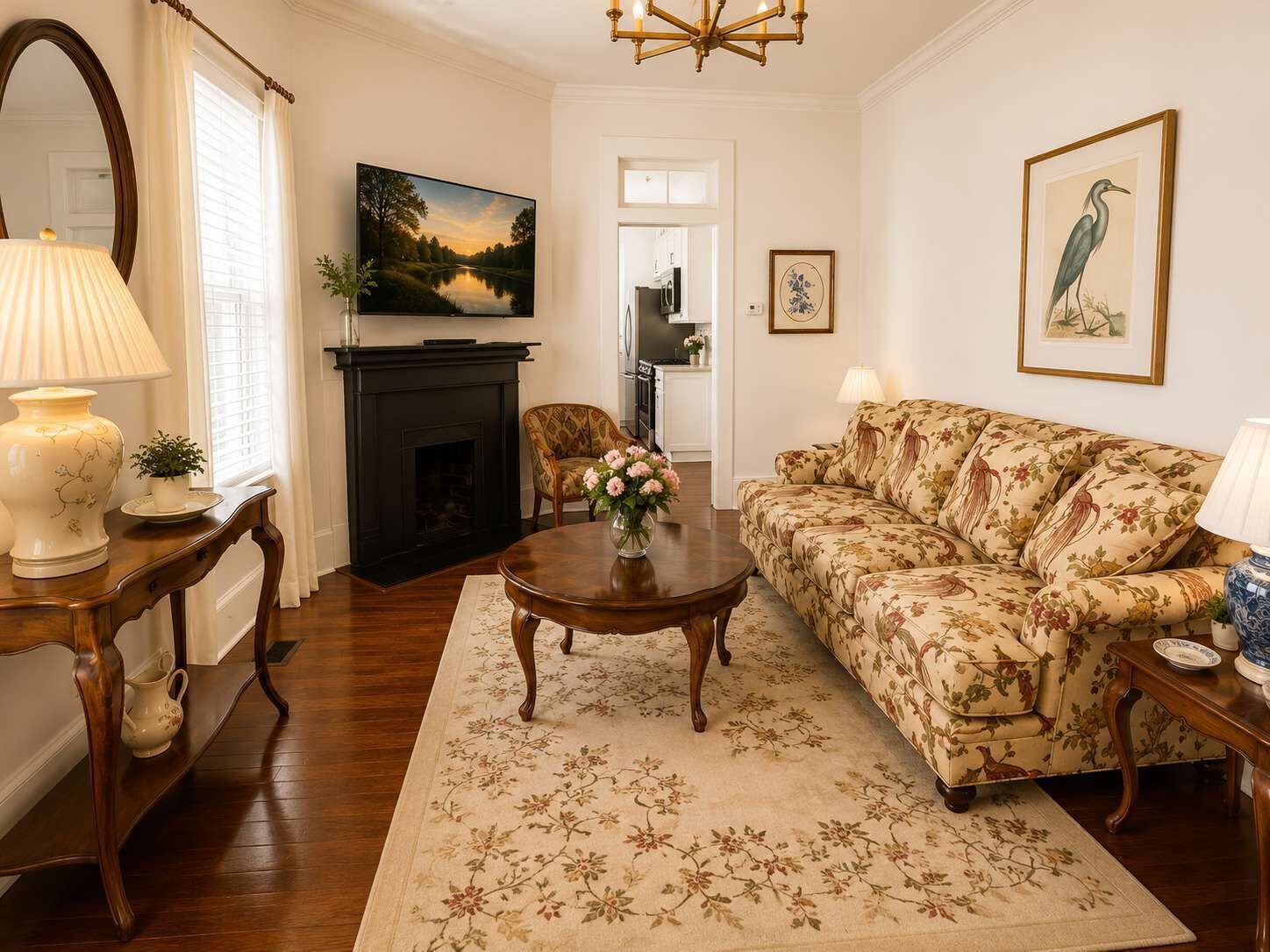 A living room with a fireplace, a sofa, a coffee table, and a television.