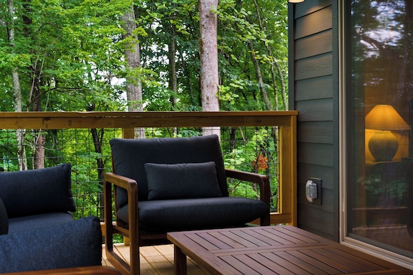 Step onto the spacious upper deck and enjoy the fresh mountain air, with comfortable lounge seating and an outdoor dining area made for relaxing and reconnecting.