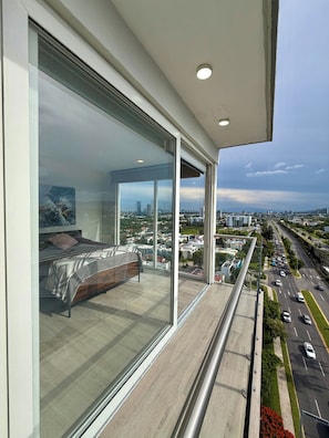 A modern bedroom with a large window overlooking a cityscape. - Agave House | panoramic view | near Andares and hospitals (Zapopan)