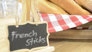 A sign labeled 'French Sticks' on a wooden stand.
