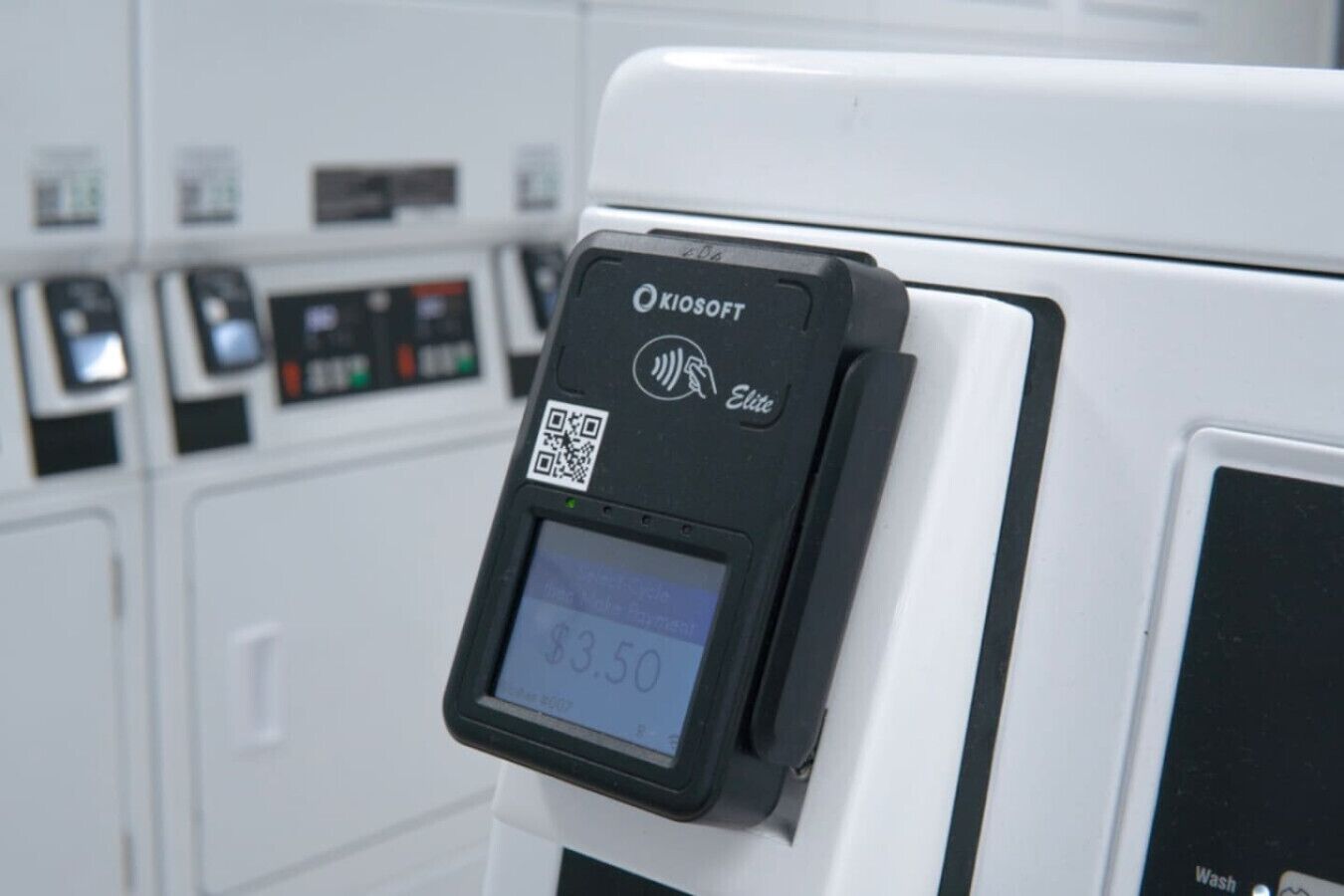A Microsoft Elite self-service kiosk with a QR code and a display showing '$3.50'.