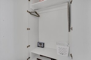A white cabinet with a small box labeled 'CONAIR' and a white electronic device with multiple buttons. - Chic Studio Near Disney World + Free Parking (Kissimmee)