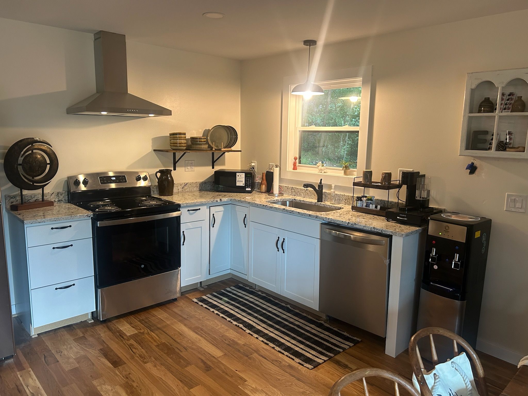 A modern kitchen with a stove, oven, microwave, and dishwasher.