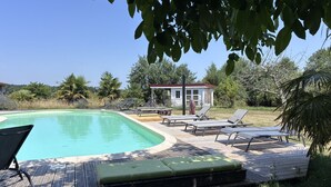 A swimming pool with lounge chairs and a small building in the background. - Maison Laurent - The Gers, at the end of the road. (Margouët-Meymes)