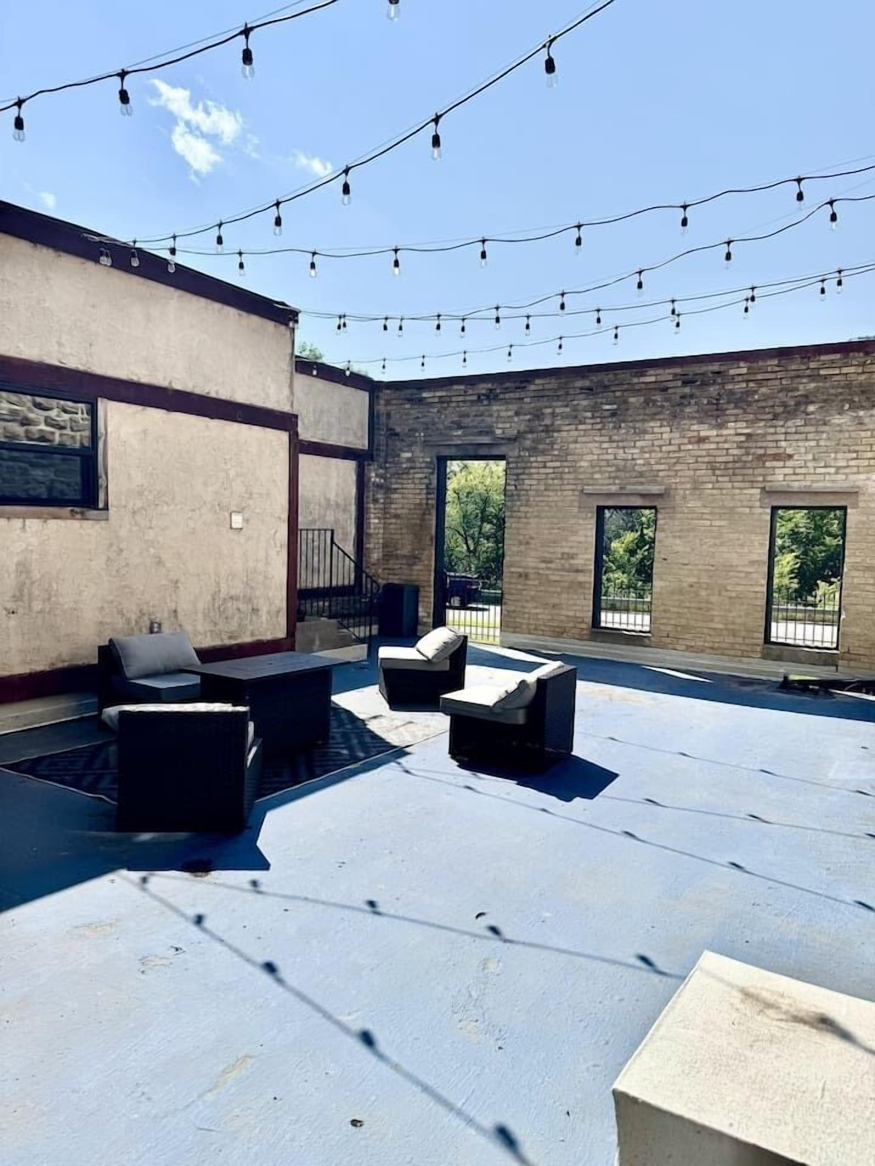 An outdoor patio area with seating and string lights.