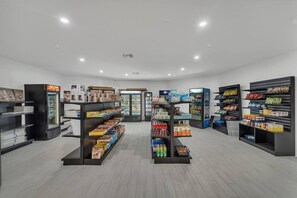 A clean, well-lit store with shelves stocked with various products, including snacks and beverages. - Spacious Stay Near Disney + Free Parking | Orl (Kissimmee)
