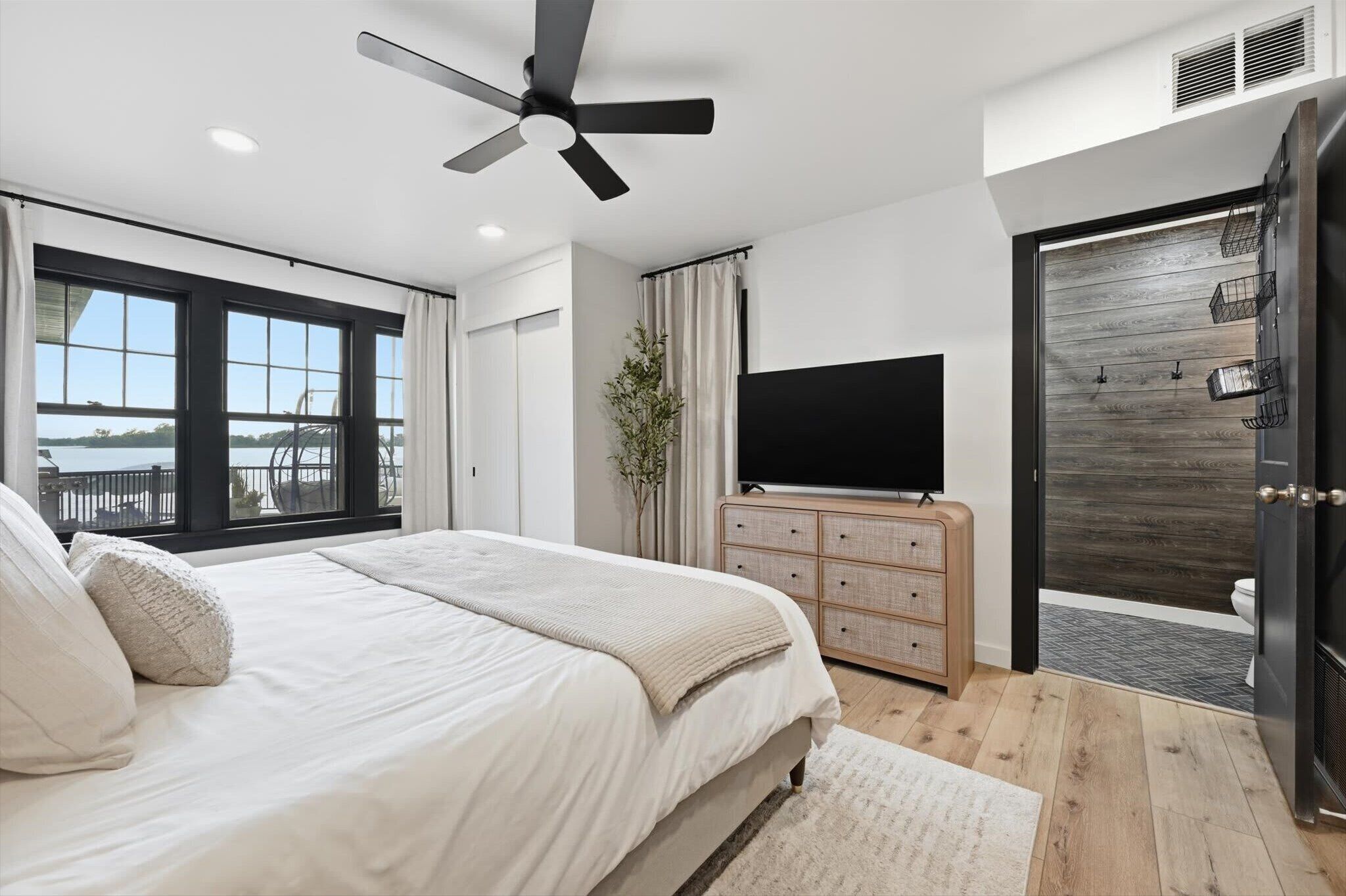 Primary bedroom features private bath en-suite and smart tv with closet and storage space for your belongings 