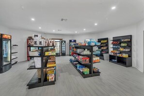 A clean, well-lit store with shelves stocked with various products, including beverages and snacks. - Family Retreat 7 Min to Disney + Parking | Orl (Kissimmee)