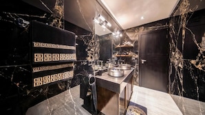 A modern bathroom with a marble vanity, a towel rack, and a mirror. - Art Gallery Design Apartment Marrakech (Marrakech)