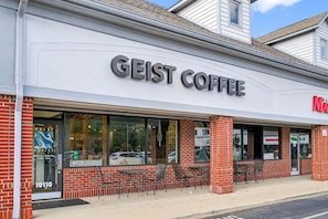 A storefront with the name 'GEIST COFFEE' and a visible address number '10110'. - Roadmap Lodging: Geist Waterfront 4BR, Fishers (Fishers)