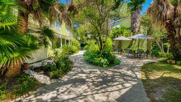 A pathway leading to a house with a patio area.