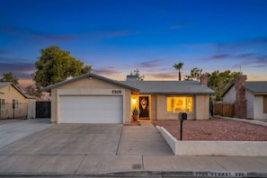 A single-story house with a garage, a front porch, and a driveway.