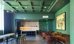 A modern interior with a bar area, seating, and a large abstract painting. - The Crosby | Apt w/ Water View | Gym & Pool Access (Miami)