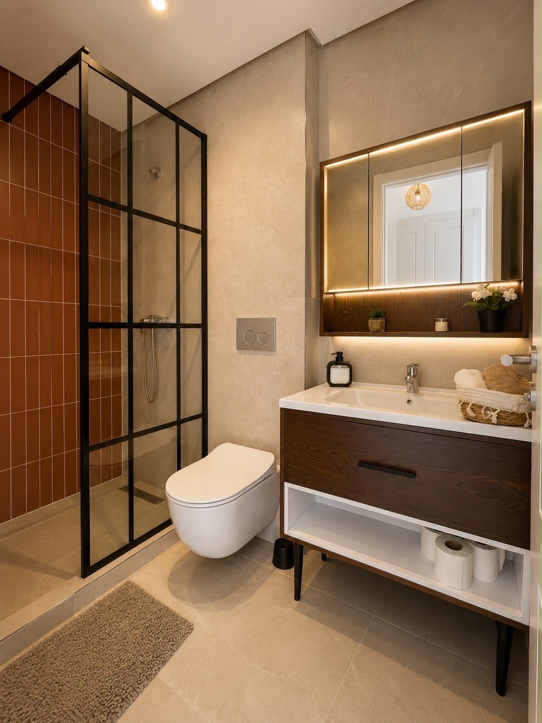 A modern bathroom with a glass shower enclosure, a toilet, a vanity with a mirror, and a sink.