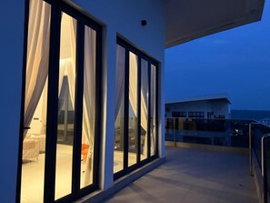 A modern building with large glass windows and a balcony. - 3 bedroom all ensuite split level luxury penthouse with skyline views over Abuja (Abuja)