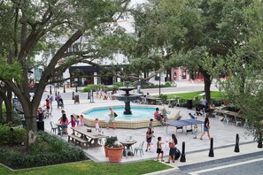 A public square with a central fountain, seating areas, and surrounding greenery. - Cozy Private 1-BR Ground Unit with Kitchen - 5111A (Tampa)