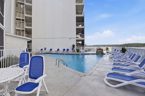 A poolside area with lounge chairs and a swimming pool. - Main-channel Views, Heated Pool, Boat Slips & Huge Deck (Osage Beach)