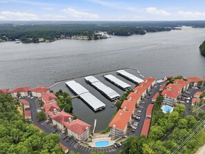 A waterfront hotel with multiple buildings, a dock, and a swimming pool. - Main Channel Views, 3 Heated Pools & Gated Resort (Lake Ozark)