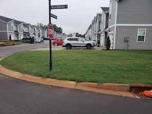 A residential street with houses, a stop sign, and a parked car. - Charming bedroom in fantastic Spartanburg with cool AC (Spartanburg)