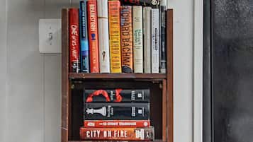 A bookshelf with various books and decorative items.