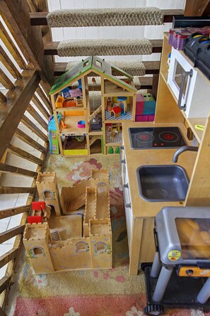 A playhouse with a kitchen area including a sink and stove.