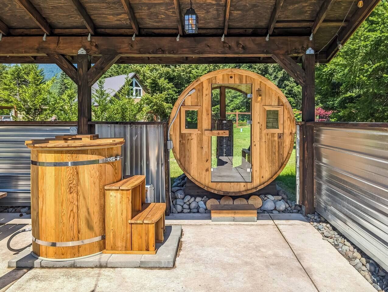A wooden structure with a circular opening, benches, and a stone pathway.