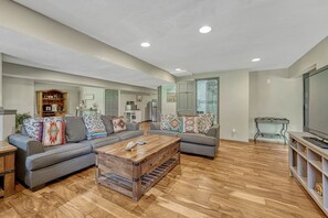 A living room with a sofa set, a coffee table, and a television. - Spacious 5-bedroom house in peaceful Monument perfect for families (Monument)