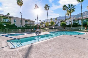 A pool area with multiple pools, palm trees, and a mountainous backdrop. - Canyon Country Club Chic (Palm Springs)