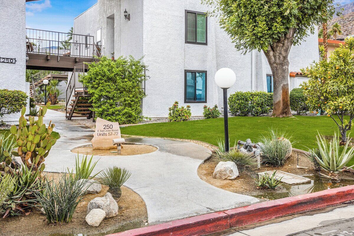 A residential building with a sign indicating '250 E. San Jose Road Units 57-59.'