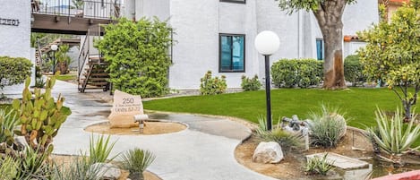 A residential building with a sign indicating '250 E. San Jose Road Units 57-59.'