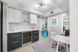 A modern kitchen with a white countertop, hexagonal backsplash, and a built-in oven. - Biltmore Gem - South Palm Springs (Palm Springs)