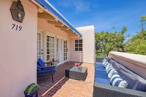 A residential property with a patio, a number 719 sign, a door, and a window. - Deauville Amora - Downtown PS (Palm Springs)