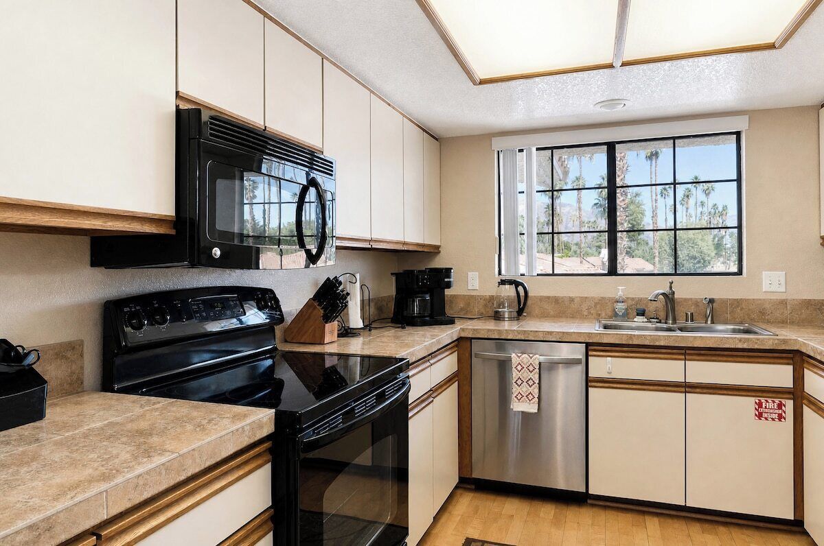 A kitchen with a stove, microwave, and dishwasher.