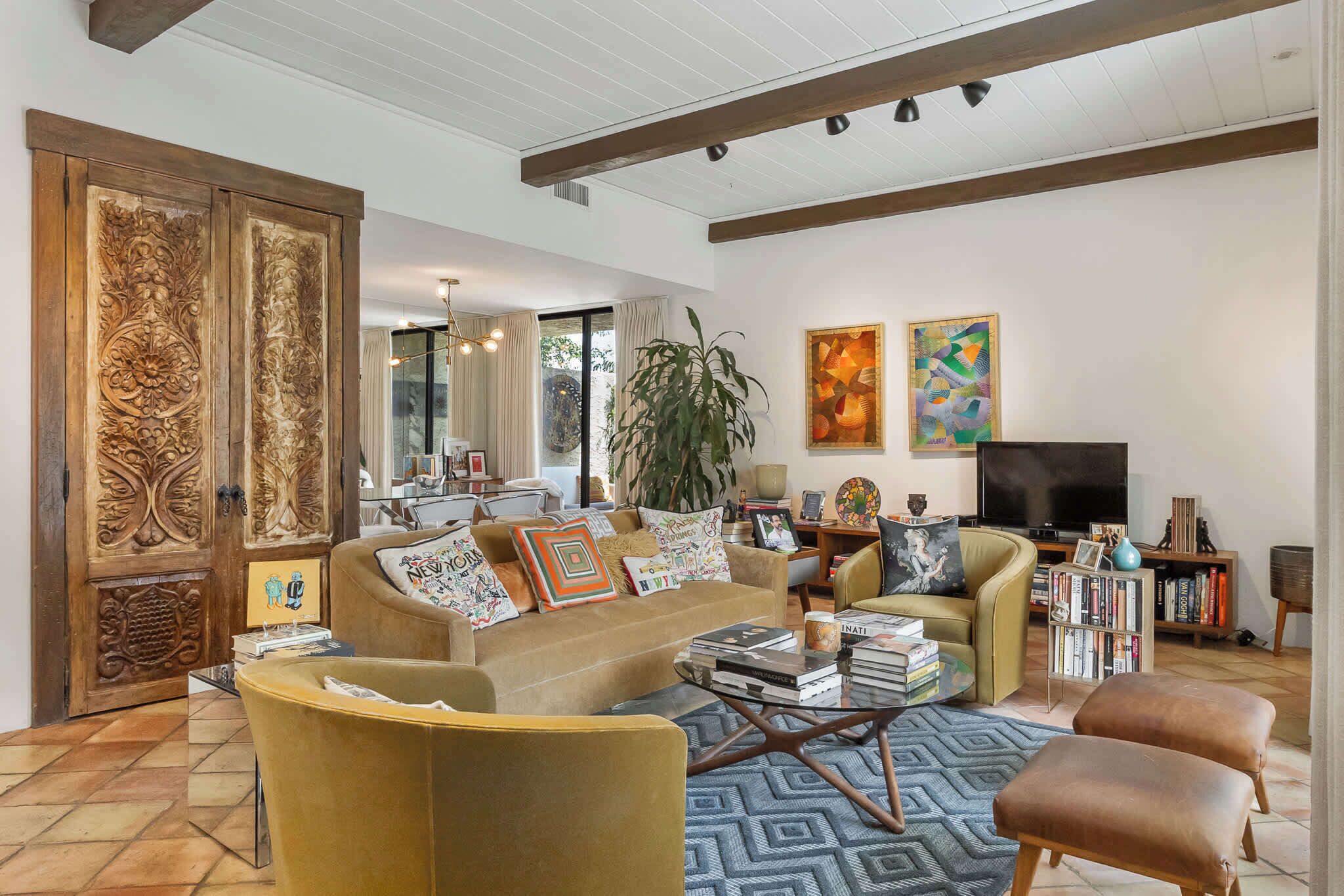 A spacious living room with a sofa set, a coffee table, and a television.