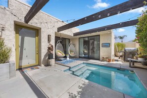 A pool area with a built-in hot tub, outdoor seating, and a barbecue grill. - Charming single-story condo boasts three bedrooms (Palm Springs)